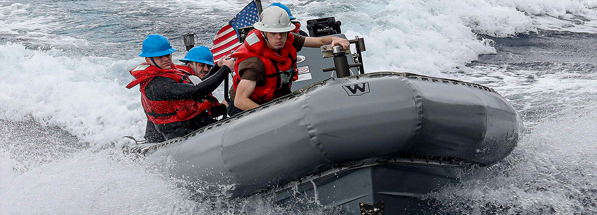 Sailors assigned to the Arleigh Burke-class guided-missile destroyer USS Rafael Peralta (DDG 115) operate a rigid-hull inflatable boat during a man overboard drill in the Philippine Sea, Jan. 22, 2023